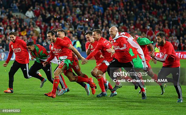 Gareth Bale and James Collins of Wales celebrate qualification with their team mates after the UEFA EURO 2016 Qualifier match between Wales and...