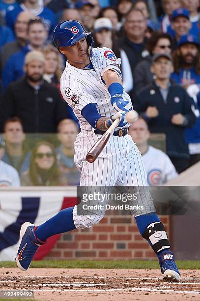 Javier Baez of the Chicago Cubs hits a three-run home run in the second inning against the St. Louis Cardinals during game four of the National...