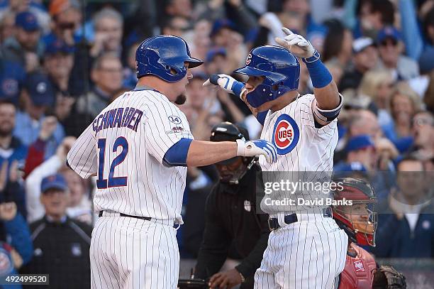 Javier Baez of the Chicago Cubs is congratulated by Kyle Schwarber of the Chicago Cubs after hitting a three-run home run in the second inning...