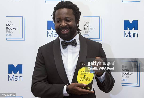 Marlon James author of "A Brief History of Seven Killings" poses for photographers after winning the Man Booker Prize for Fiction 2015 at The...
