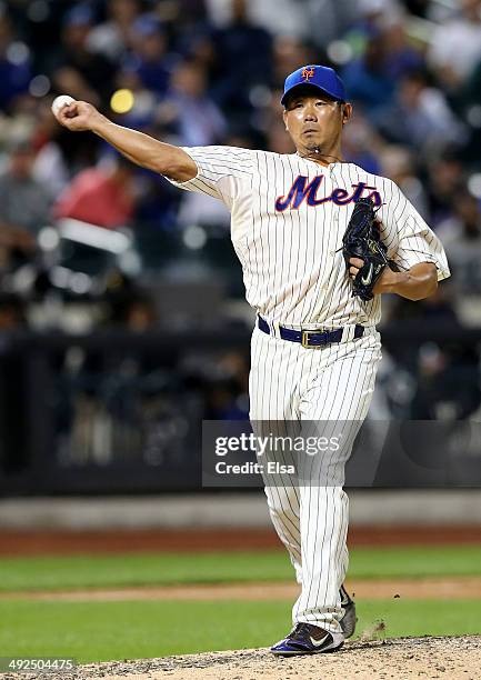 Daisuke Matsuzaka of the New York Mets sends the ball to first in an attempt to pick off Yasiel Puig of the Los Angeles Dodgers at first base in the...