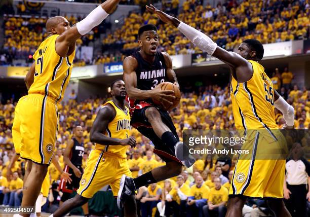 Norris Cole of the Miami Heat goes to the basket as David West and Roy Hibbert of the Indiana Pacers defend during Game Two of the Eastern Conference...