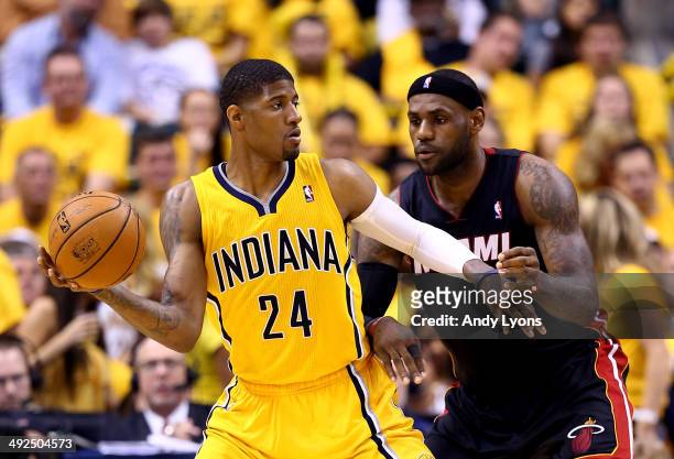 Paul George of the Indiana Pacers looks to pass as LeBron James of the Miami Heat defends during Game Two of the Eastern Conference Finals of the...