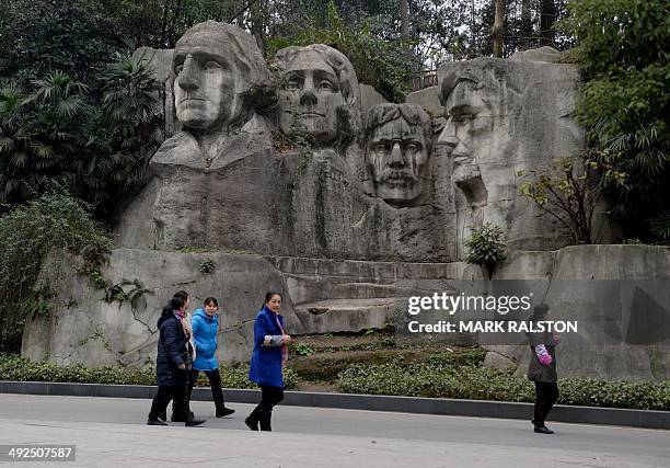 China-culture-architecture-trade-offbeat,FEATURE by Carol Huang This photo taken on on February 21, 2014 shows people walking past a copy of Mount...