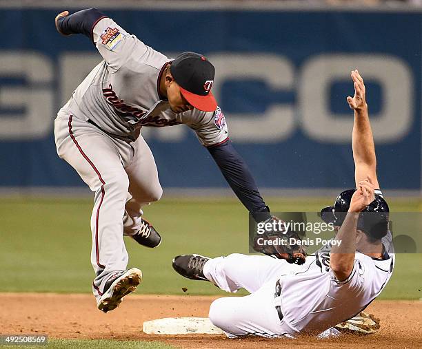 Seth Smith of the San Diego Padres steals second base ahead of the tag of Eduardo Escobar of the Minnesota Twins during the sixth inning of a...