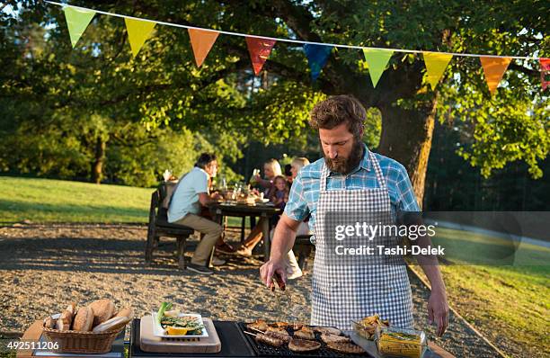 family enjoying a barbeque - burger with flag stock pictures, royalty-free photos & images