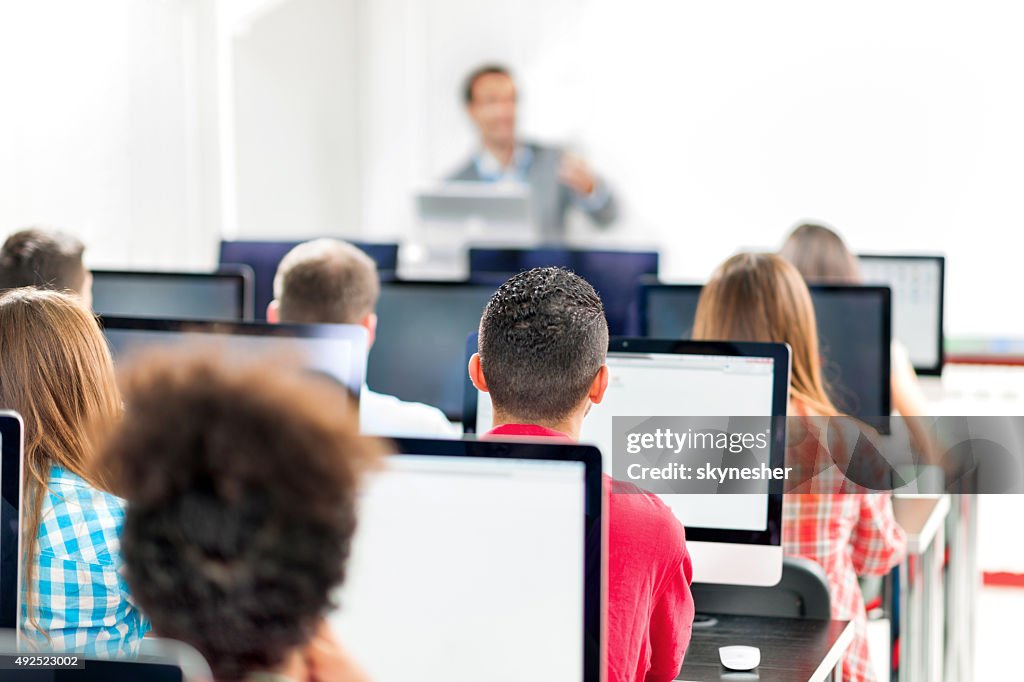 Rear view of group of people in a computer lab.