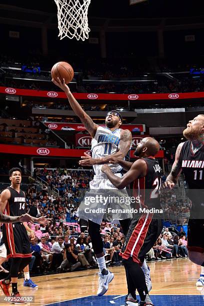 Devyn Marble of the Orlando Magic goes for the layup against John Lucas III of the Miami Heat during a preseason game on October 13, 2015 at Amway...