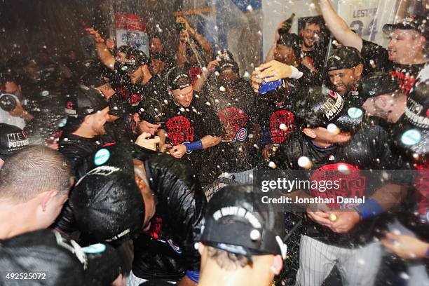 The Chicago Cubs celebrate in the clubhouse after defeating the St. Louis Cardinals in game four of the National League Division Series to win the...