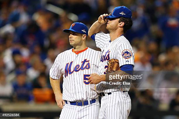 Steven Matz and David Wright of the New York Mets react after giving up a run in the third inning against the Los Angeles Dodgers during game four of...