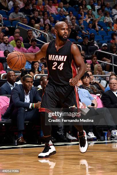 John Lucas III of the Miami Heat drives to the basket against the Orlando Magic during a preseason game on October 13, 2015 at Amway Center in...