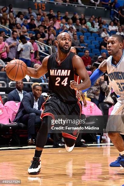 John Lucas III of the Miami Heat drives to the basket against C.J. Watson of the Orlando Magic during a preseason game on October 13, 2015 at Amway...