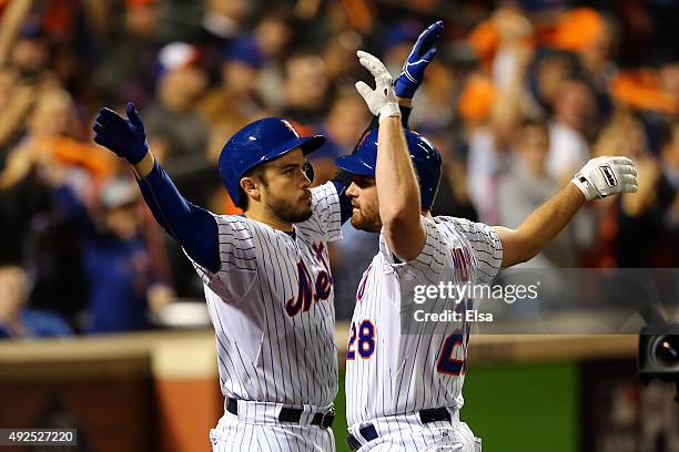 Daniel Murphy of the New York Mets celebrates with teammate Travis d'Arnaud after hitting a solo home run in the fourth inning against Clayton...