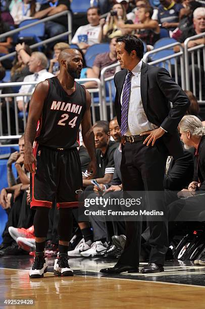 John Lucas III speaks with head coach, Erik Spoelstra of the Miami Heat during a preseason game on October 13, 2015 at Amway Center in Orlando,...