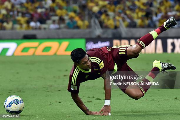 Venezuela's Ronald Vargas falls during their Russia 2018 FIFA World Cup South American Qualifiers football match against Brazil, at the Estadio...