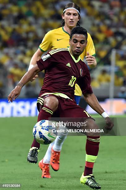 Venezuela's Ronald Vargas is marked by Brazil's Felipe Luis during their Russia 2018 FIFA World Cup South American Qualifiers football match, at the...