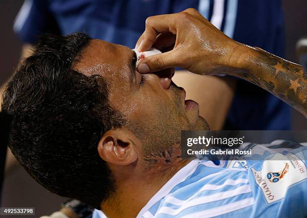 Carlos Tevez of Argentina laments after receiving a foul from Victor Caceres of Paraguay during a match between Paraguay and Argentina as part of...