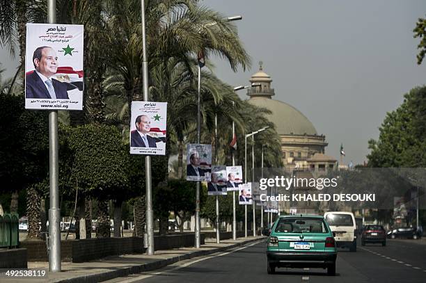 Posters of Egyptian ex-army chief and leading presidential candidate Abdel Fattah al-Sisi are seen outside Cairo University in the capital on May 21,...