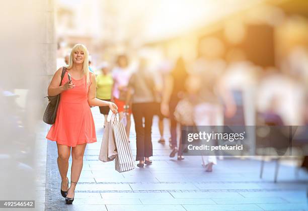 beautiful woman walking down the street with shopping bags - knez mihailova street stock pictures, royalty-free photos & images