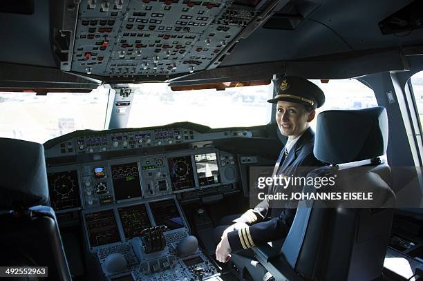 Co-pilot Angelika Barufke poses in the cockpit of an Airbus A380 from Emirates airlines during the International Air Show ILA in Schoenefeld near...