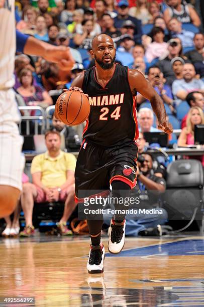 John Lucas III of the Miami Heat drives to the basket against the Orlando Magic during a preseason game on October 13, 2015 at Amway Center in...