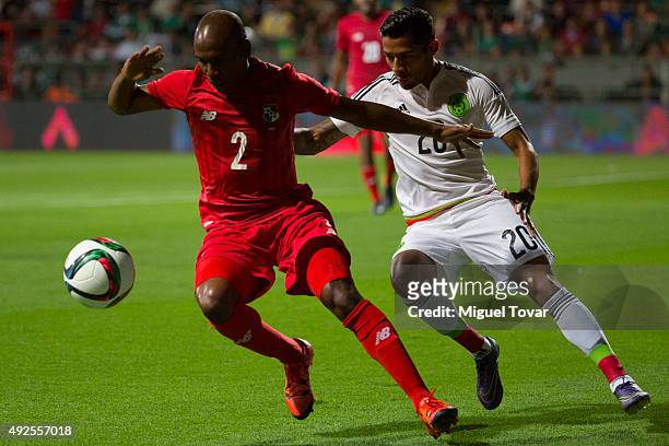 Javier Aquino of Mexico fights for the ball with Leonel Parra of Panama during the International Friendly match between Mexico and Panama at Nemesio...
