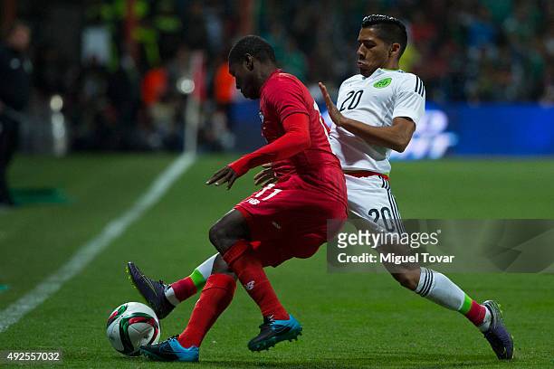 Javier Aquino of Mexico fights for the ball with Armando Cooper of Panama during the International Friendly match between Mexico and Panama at...