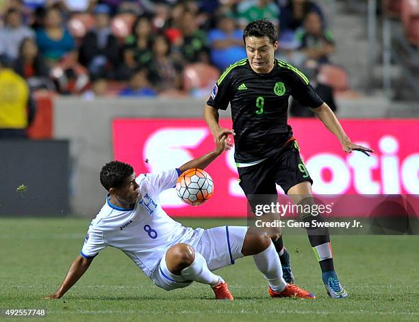 Rodolfo Espinal of Honduras and Erick Torres of Mexico try for the ball in the first half of the final CONCACAF Olympic Qualifying match at Rio Tinto...