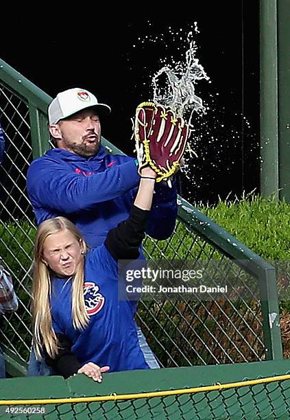 Fans of the Chicago Cubs try to catch a home run ball hit by Stephen Piscotty of the St. Louis Cardinals in the 1st inning during game four of the...