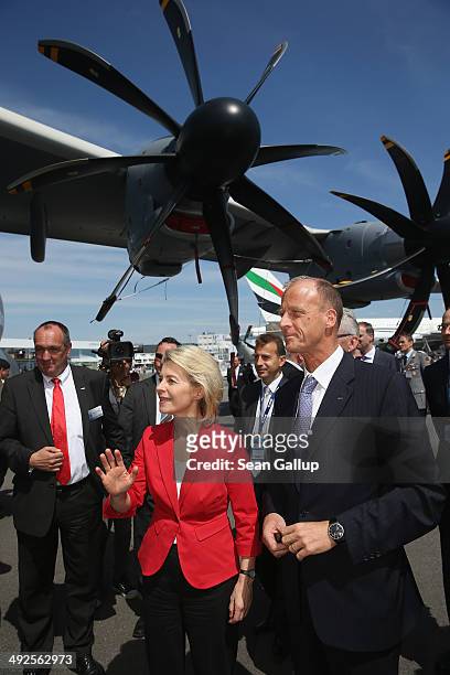 German Defense Minister Ursula von der Leyen and Thomas Enders, CEO of Airbus, stand under an Airbus A400M transport plane at the ILA 2014 Berlin Air...