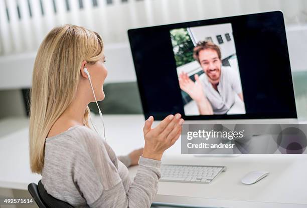 woman at home video chatting with her boyfriend - distant meeting stock pictures, royalty-free photos & images