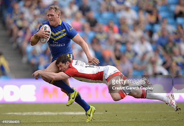 Ben Westwood of Warrington Wolves is tackled by Paul Wellens of St Helens during the Super League match between Warrington Wolves and St Helens at...