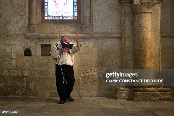 Jewish man recites the Psalm of David inside to the Cenacle or Upper Room on Mount Zion just outside the Old City of Jerusalem, on May 21, 2014. For...