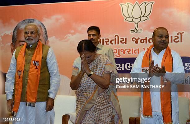 Gujarat's first woman chief minister, Anandiben Patel greets the audience as Indian prime minister-elect, Narendra Modi and BJP central observer...