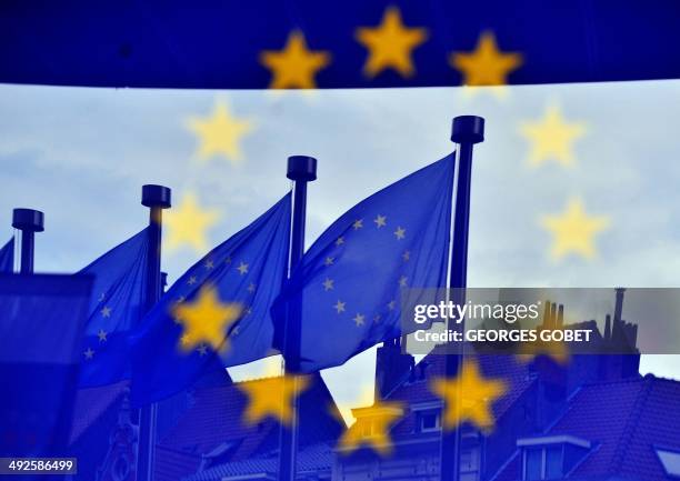 European flags are reflected at the entrance of the Berlaymont building EU Commission in Brussels on May 21,2014. Britain and the Netherlands kick...