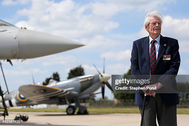 Day veteran Paddy Byrne poses alongside an RAF Eurofighter Typhoon and RAF Spitfire during the unveiling of the commemorative D-Day Eurofighter...