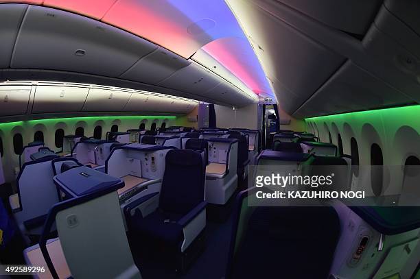 Business class seats on board the All Nippon Airways Boeing 787-9 or R2-D2 ANA JET are lit with colorful lighting during a press preview at Tokyo's...