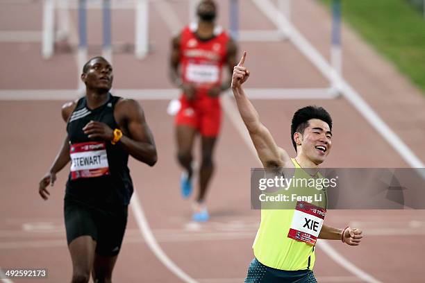 Chinese hurdler Xie Wenjun celebrates winning the men's 110-meter hurdles during 2014 IAAF World Challenge Beijing at National Stadium on May 21,...