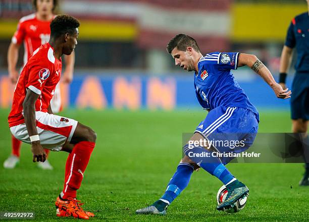 David Alaba of Austria competes for the ball with Sandro Wieser of Liechtenstein during the UEFA EURO 2016 Qualifier between Austria and...