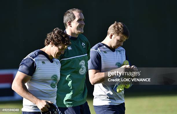 Ireland's back row Mike Mccarthy , lock Devin Toner and lock Iain Henderson arrive for a training session in Cardiff, south Wales, on October 14...