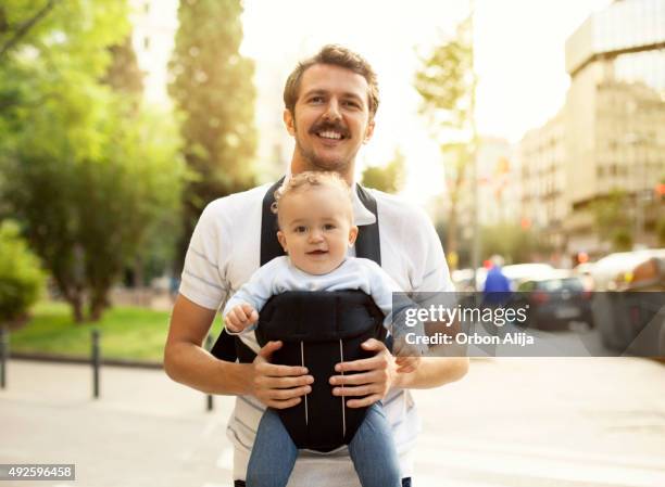 father and toddler - baby carrier stock pictures, royalty-free photos & images