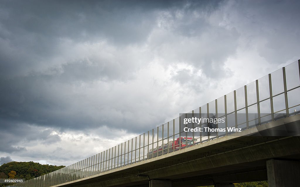 Transparent noise barrier on a freeway bridge