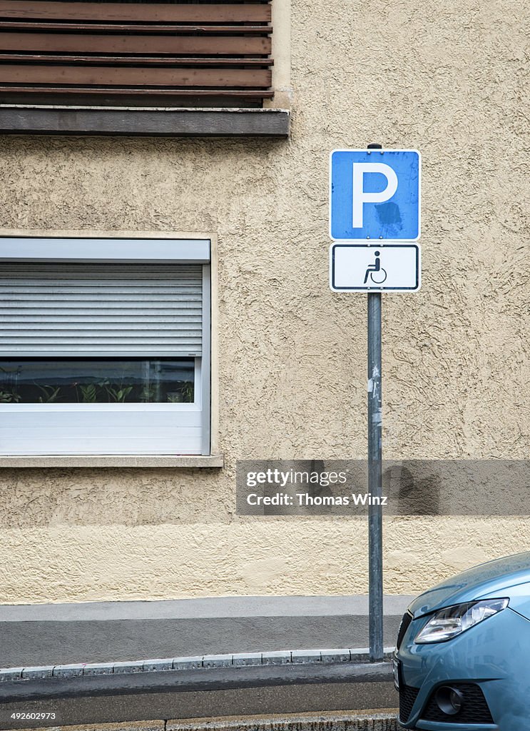 Handicapped parking sign and car