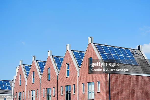 modern dutch houses with solar panels on roof - heerhugowaard stock pictures, royalty-free photos & images