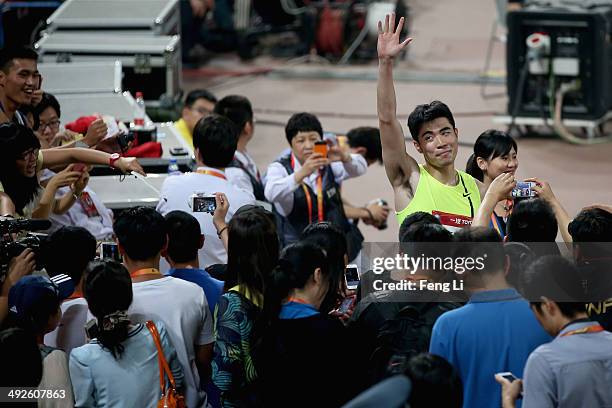 Chinese hurdler Xie Wenjun celebrates winning the men's 110-meter hurdles during 2014 IAAF World Challenge Beijing at National Stadium on May 21,...