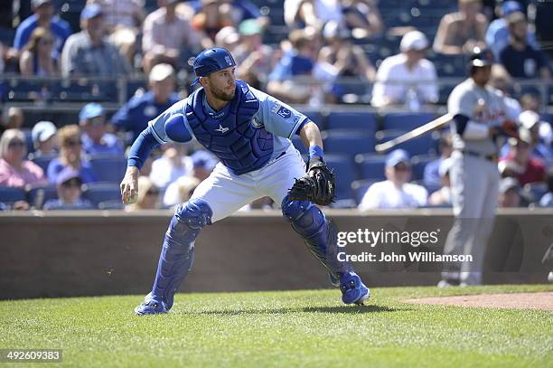 Catcher Brett Hayes of the Kansas City Royals fields his position as he throws to third base after retrieving a wild pitch in the game against the...