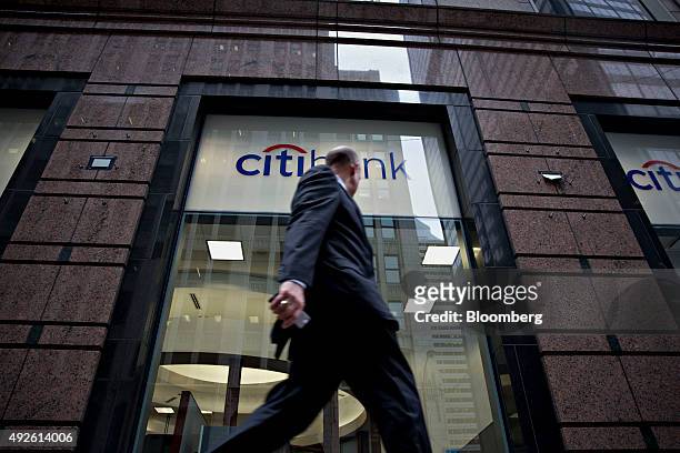 Pedestrian walks past a Citibank branch in Chicago, Illinois, U.S., on Monday, Oct. 5, 2015. Citigroup Inc. Is expected to report quarterly earnings...