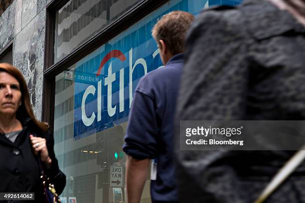 Pedestrians walk past a Citibank branch in Chicago, Illinois, U.S., on Monday, Oct. 5, 2015. Citigroup Inc. Is expected to report quarterly earnings...
