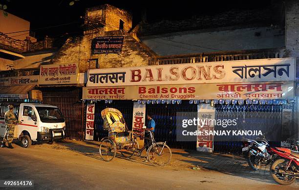 An Indian rickshaw puller waits for passengers outside a closed drugstore during a nationwide strike called by the All India Organisation of Chemists...