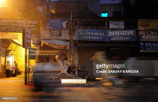An Indian rickshaw puller waits for passengers outside a closed drugstore during a nationwide strike called by the All India Organisation of Chemists...